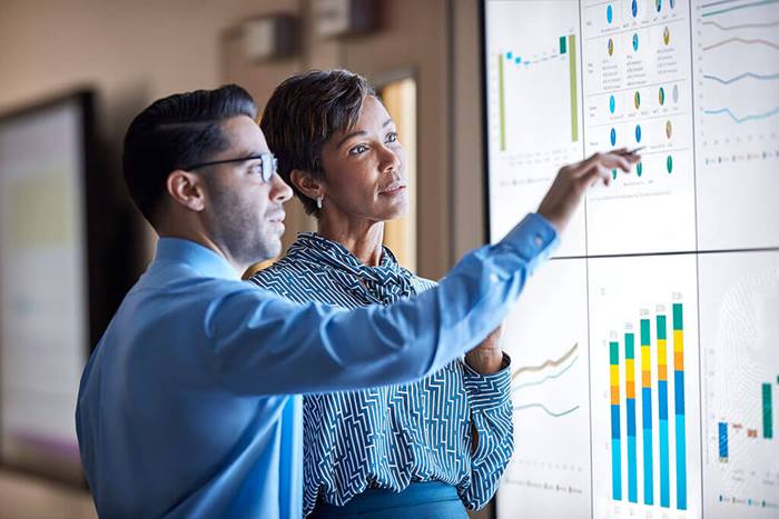 male pointing at tv wall screen